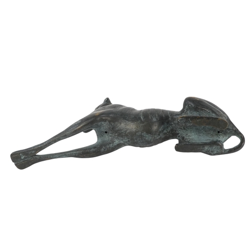 24 - An Art Deco style bronze dog - modelled as a greyhound in a recumbent pose, 26cm wide.