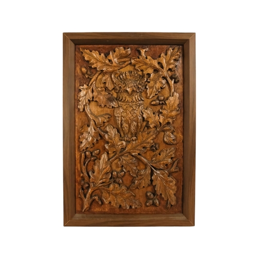 33 - A 20th century carved oak panel - showing a owl in an oak tree, 66 x 45cm.
