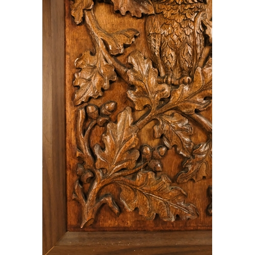 33 - A 20th century carved oak panel - showing a owl in an oak tree, 66 x 45cm.