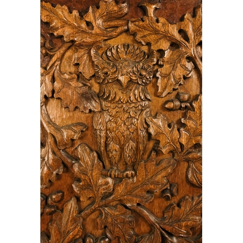 33 - A 20th century carved oak panel - showing a owl in an oak tree, 66 x 45cm.