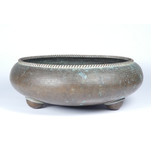 38 - An Arts and Crafts style copper bowl - attributed to Gordon Russell, of squat circular form with rop... 
