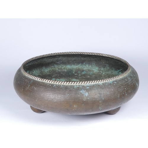 38 - An Arts and Crafts style copper bowl - attributed to Gordon Russell, of squat circular form with rop... 