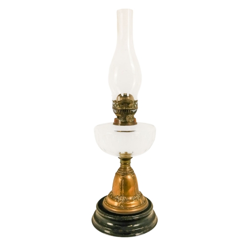 40 - A late Victorian oil lamp - with a flash-cut clear glass reservoir on a repousse brass support and c... 