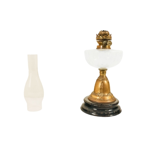 40 - A late Victorian oil lamp - with a flash-cut clear glass reservoir on a repousse brass support and c... 