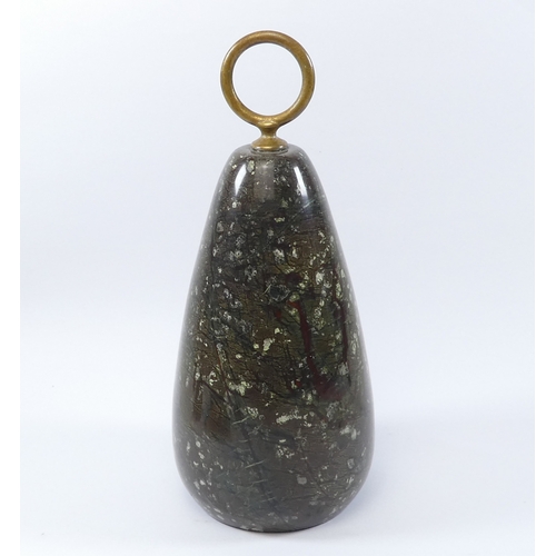 41 - A serpentine door stop - of teardrop form with a ring handle, 28cm high.