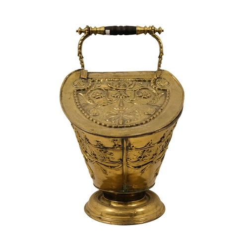 5 - A late 19th/early 20th century brass coal scuttle - oval with twin covers repousse decorated with fo... 