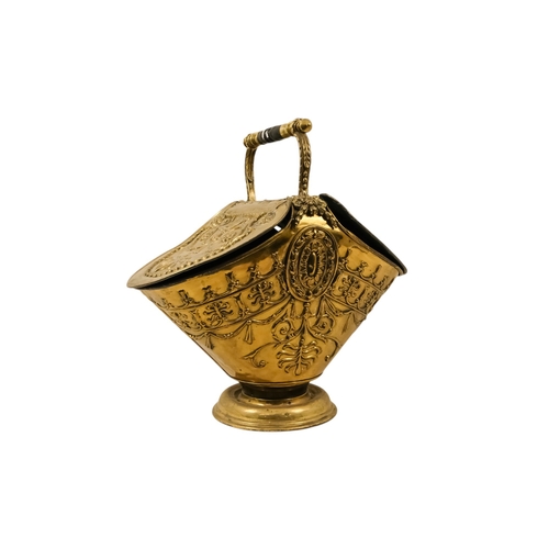 5 - A late 19th/early 20th century brass coal scuttle - oval with twin covers repousse decorated with fo... 