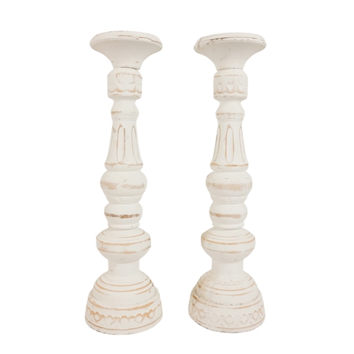 57 - A pair of contemporary church style candlesticks - of baluster form and painted white, 44cm high. (2... 