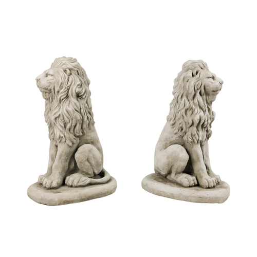 58 - A pair of reconstituted stone lions - in a seated pose, 40cm high. (2)