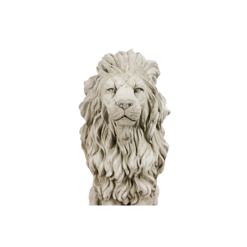 58 - A pair of reconstituted stone lions - in a seated pose, 40cm high. (2)
