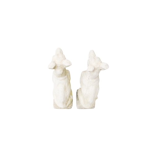 60 - A pair of large reconstituted stone gate capitals - modelled as greyhounds, 76cm high. (2)