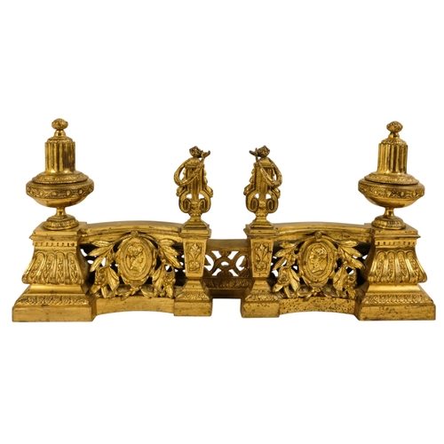 8 - A set of French 19th century gilt metal chenets - together with fender rail, the chenets with classi... 