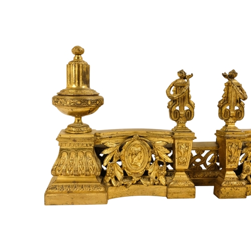 8 - A set of French 19th century gilt metal chenets - together with fender rail, the chenets with classi... 