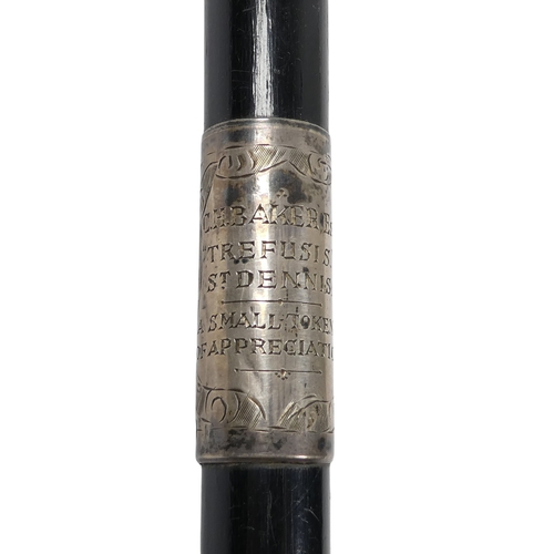 9 - An ebonised baton - London 1927, with silver foliate engraved mounts including presentation inscript... 