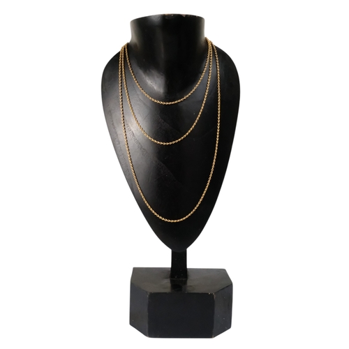 603 - A yellow metal fancy link muff chain - with a 9ct gold clasp, 145cm long, 25.3g.