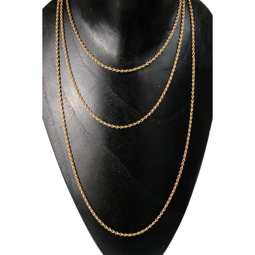 603 - A yellow metal fancy link muff chain - with a 9ct gold clasp, 145cm long, 25.3g.