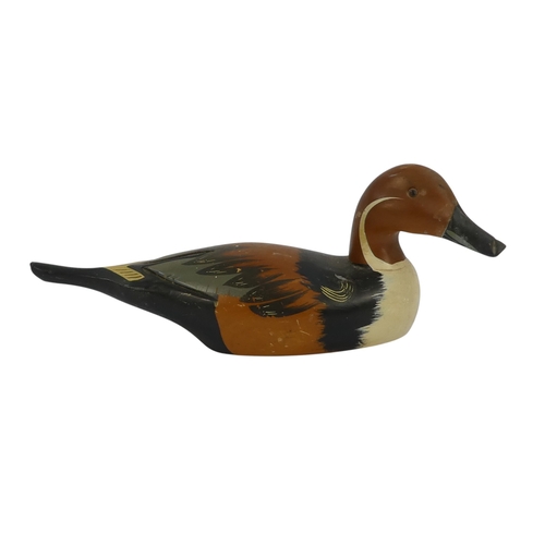 101 - A 20th century polychrome painted duck - 30cm wide, together with four other similar smaller example... 