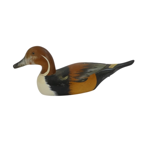 101 - A 20th century polychrome painted duck - 30cm wide, together with four other similar smaller example... 