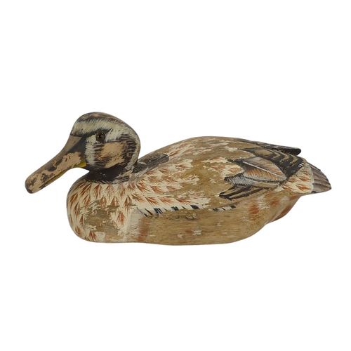 101 - A 20th century polychrome painted duck - 30cm wide, together with four other similar smaller example... 