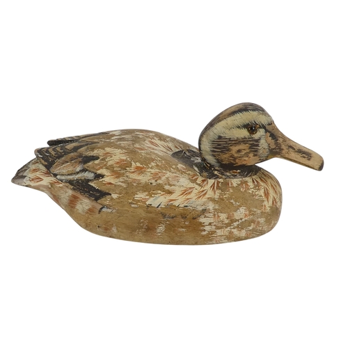 101 - A 20th century polychrome painted duck - 30cm wide, together with four other similar smaller example... 