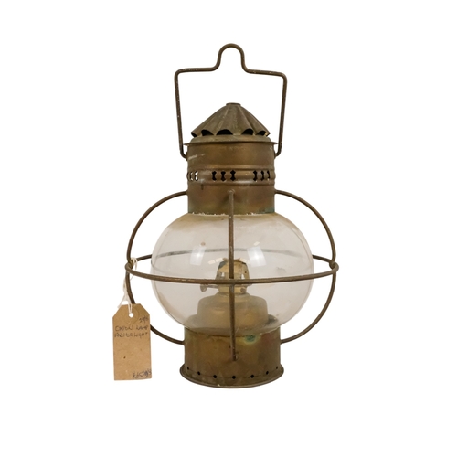 102 - An early 20th century brass anchor light - with clear glass, 32cm high.