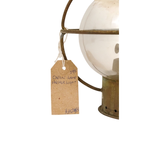 102 - An early 20th century brass anchor light - with clear glass, 32cm high.