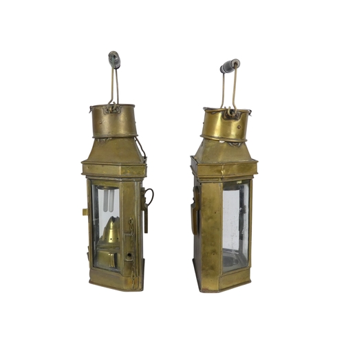 106 - A pair of brass ships lamps - of faceted form with flat backs, 41cm high.