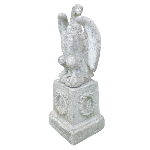 110A - A reconstituted stone eagle - with wings outstretched, height 56cm, width 45cm, raised on a plinth d... 