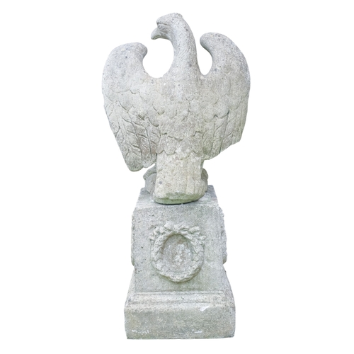 110A - A reconstituted stone eagle - with wings outstretched, height 56cm, width 45cm, raised on a plinth d... 