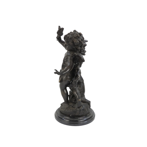 110 - A bronze figure of a cherub - blindfolded and holding a torch, 43cm high.