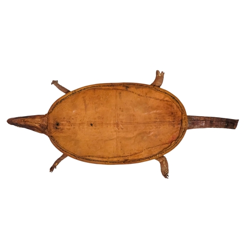 115 - A small taxidermy crocodile - the flattened body with stuffed head and limbs, 60cm long.