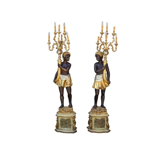 118 - A pair of Blackamoor lamps - gilded and polychrome painted, the figures holding multi-lamp torches, ... 