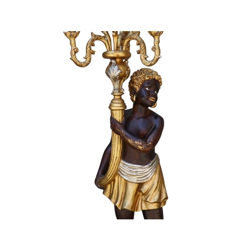118 - A pair of Blackamoor lamps - gilded and polychrome painted, the figures holding multi-lamp torches, ... 