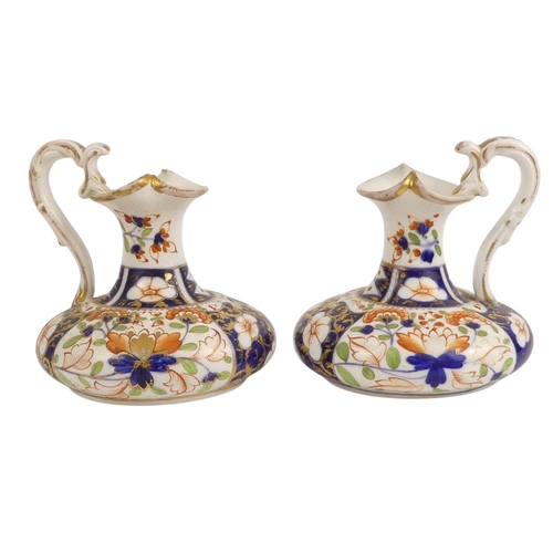 202 - A pair of Royal Crown Derby jugs - of squat form and decorated in the Imari style, marks to base, 13... 