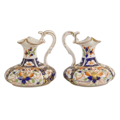 202 - A pair of Royal Crown Derby jugs - of squat form and decorated in the Imari style, marks to base, 13... 