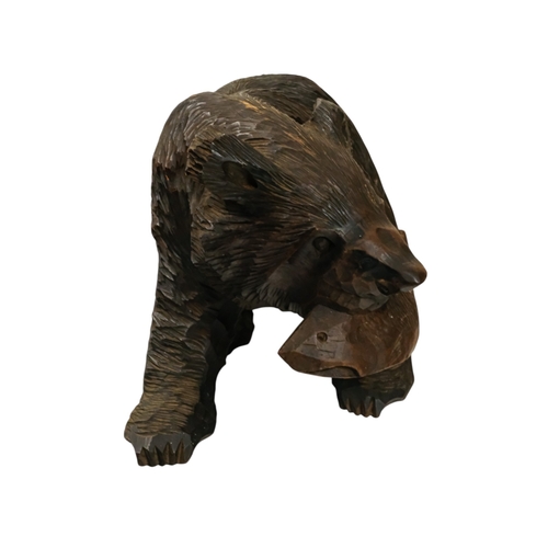 57 - A Black Forest model of a bear with a salmon - width 38cm, height 25cm.