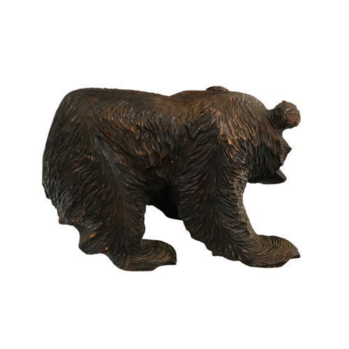 57 - A Black Forest model of a bear with a salmon - width 38cm, height 25cm.
