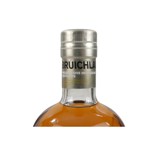 67 - A bottle of Bruichladdich Ilay single malt whisky - 70cl, 'Waves' in presentation tin, together with... 