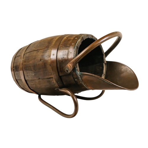 69 - A staved barrel/bucket with copper bindings, handles and lip - diameter 23cm, height 54cm.