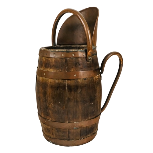 69 - A staved barrel/bucket with copper bindings, handles and lip - diameter 23cm, height 54cm.