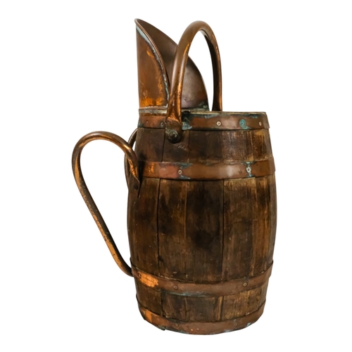69 - A staved barrel/bucket with copper bindings, handles and lip - diameter 23cm, height 54cm.