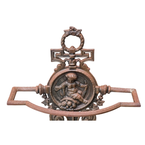 70 - A Victorian cast iron umbrella stand - decorated with a putti upon fruit, width 39cm, height 74cm.