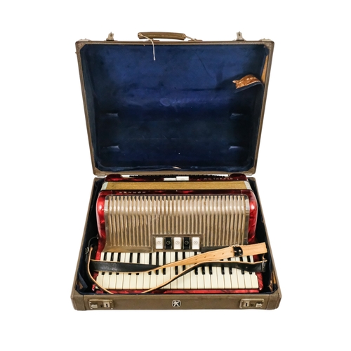 74 - A Hohner piano accordion - Carena IIIM, with a red marbled case and a grey carry case.