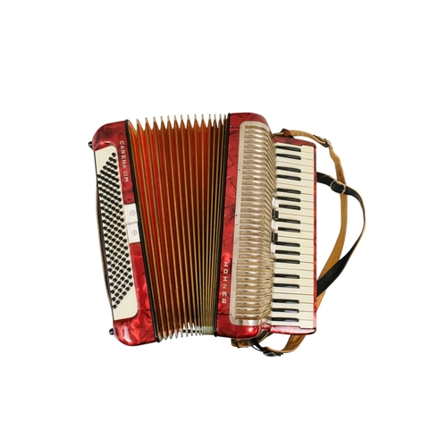 74 - A Hohner piano accordion - Carena IIIM, with a red marbled case and a grey carry case.