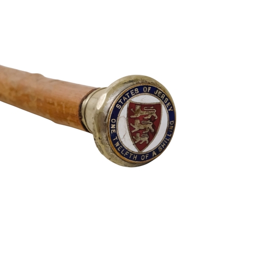 79 - A 20th century walking cane - the white metal top set with a 'States of Jersey' coin with later enam... 
