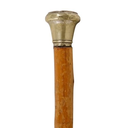 79 - A 20th century walking cane - the white metal top set with a 'States of Jersey' coin with later enam... 