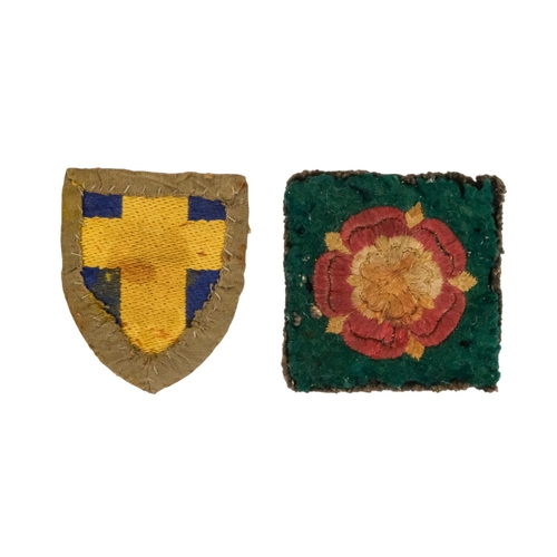 85 - A quantity of military badges and buttons.