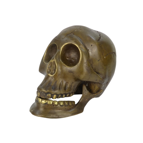 89 - A patinated bronze skull - 18cm high.