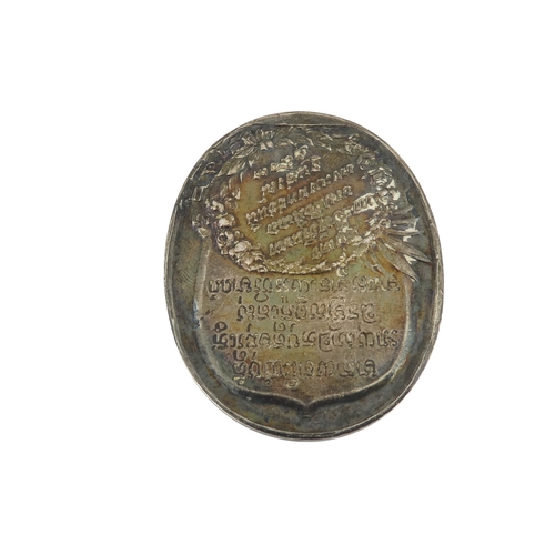 90 - A Thai royal commemorative white metal token - oval decorated with horses and script verso, together... 