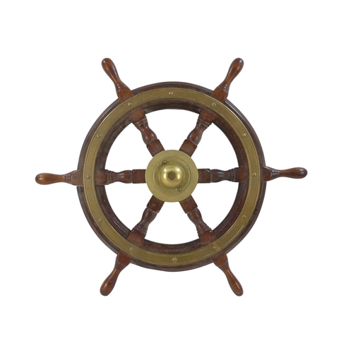 94 - A teak ship's wheel by Simpson & Lawrence - with brass binding and hub, 63cm diameter.
